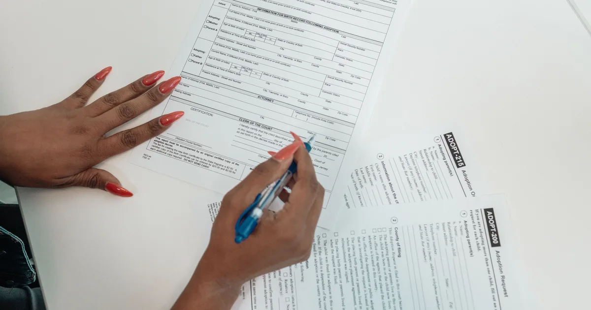 A printed application form and a pen on a desk