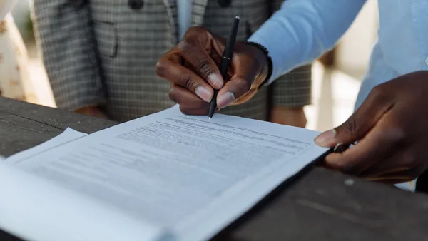 A fountain pen signing a legal document, the notarial deed that founds an Italian company