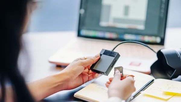 A laptop with a smart-card reader, the digital identities an Italian company and its director must hold