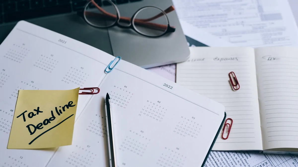 A desk calendar beside paperwork, the first year of filing deadlines