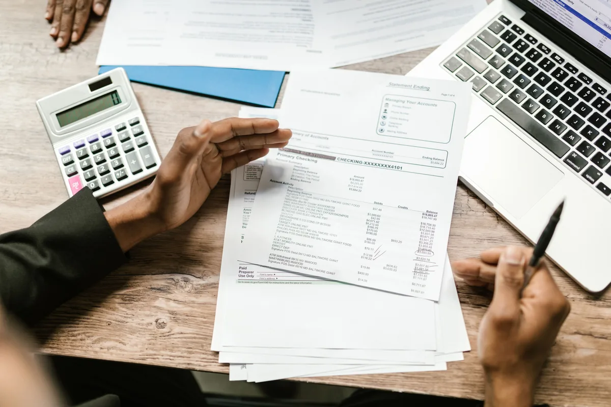 Corporate tax working papers, a calculator and a laptop on a desk