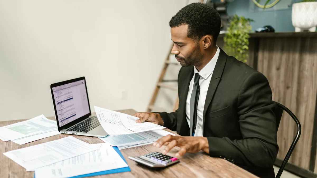Compliance officer checking client-fund safeguarding records for an e-money institution